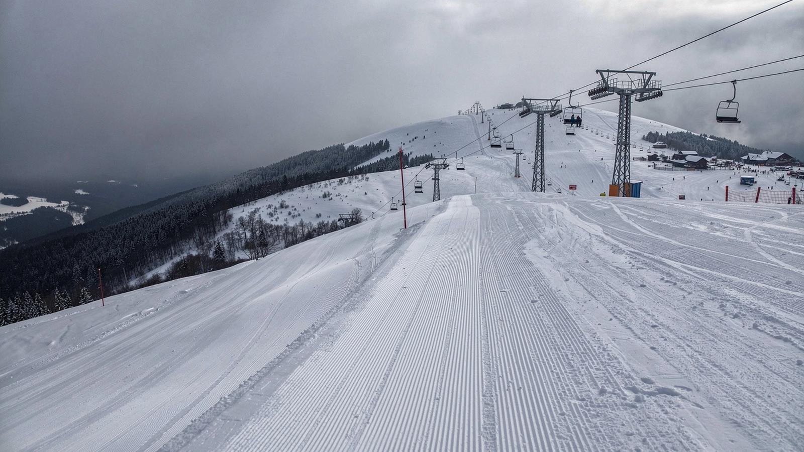 Snow-covered Carpathian ridge above a working ski resort in western Ukraine